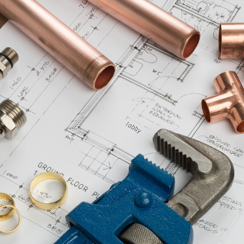 Plumbing supplies on top of blueprints